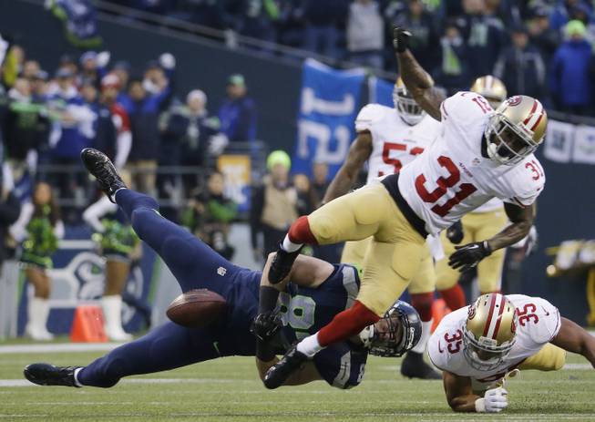 Seattle Seahawks' Luke Willson can't catch a pass as he is hit by San Francisco 49ers' Donte Whitner (31) during the first half of the NFL football NFC Championship game Sunday, Jan. 19, 2014, in Seattle. (AP Photo/Ted S. Warren)